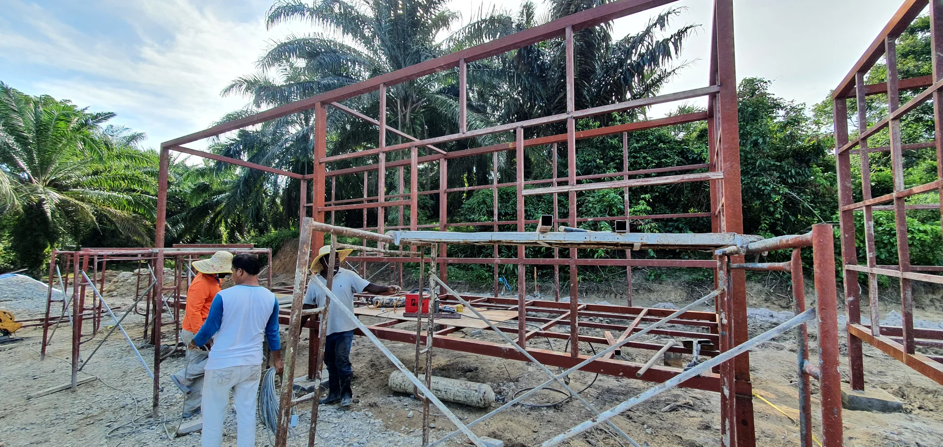 Structural steel frame pavilion assembly on concrete pad footings