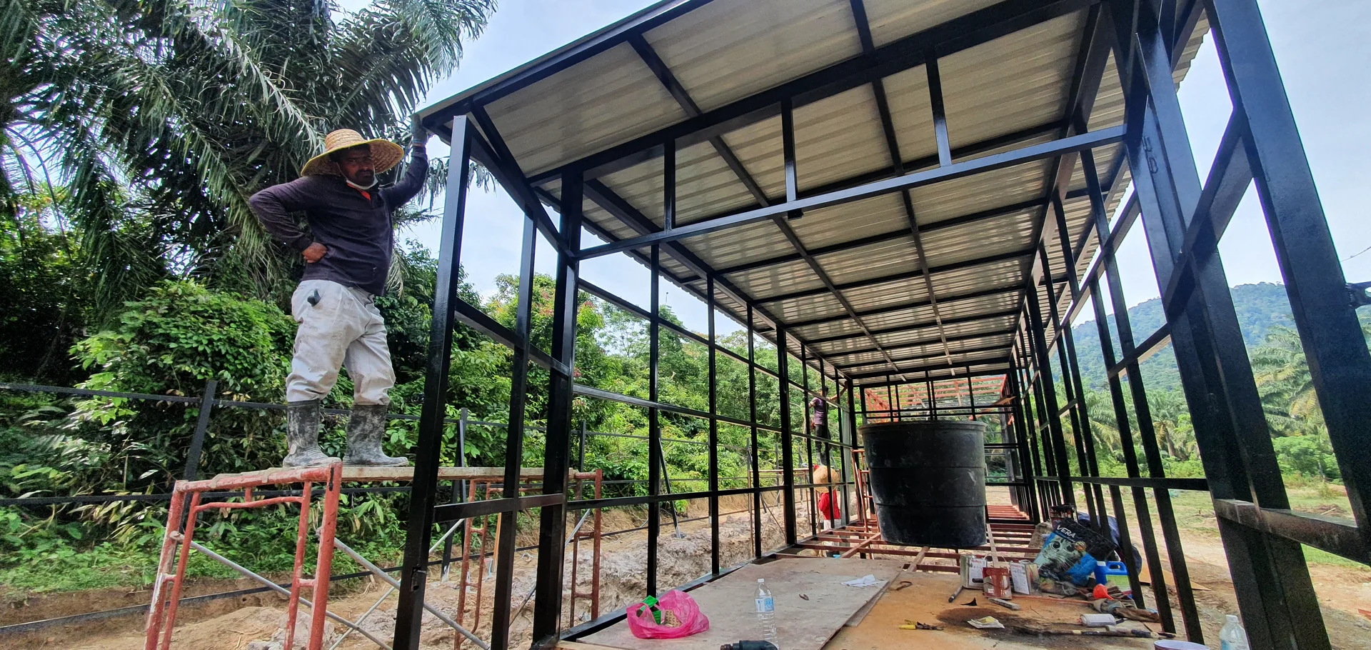 Builder fitting insulated roof envelope and water storage structure